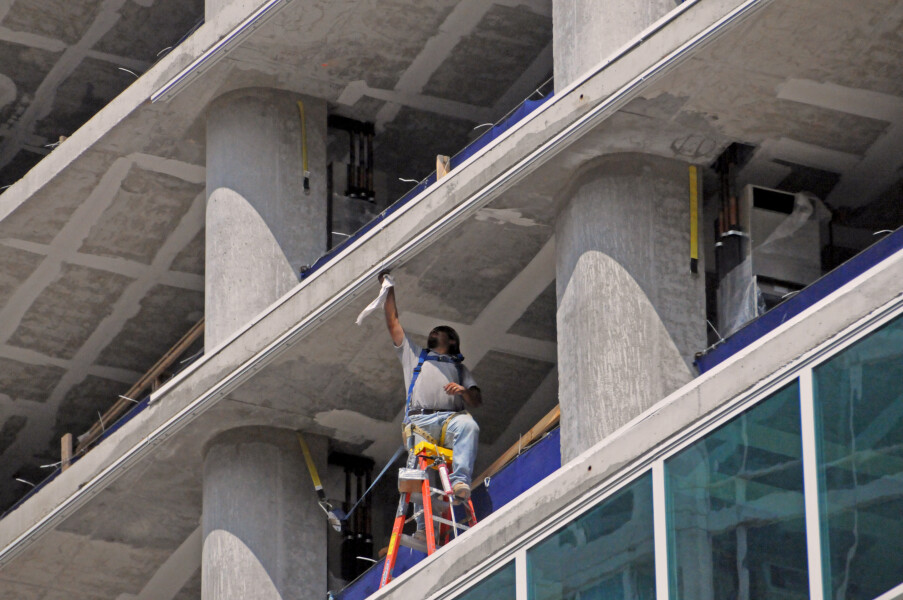 Worker adjusting the frame to hold the window glass in place