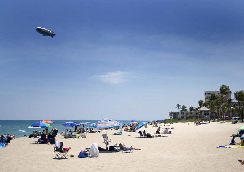 Beach scene on a sunny day and a visit from the Goodyear Blimp
